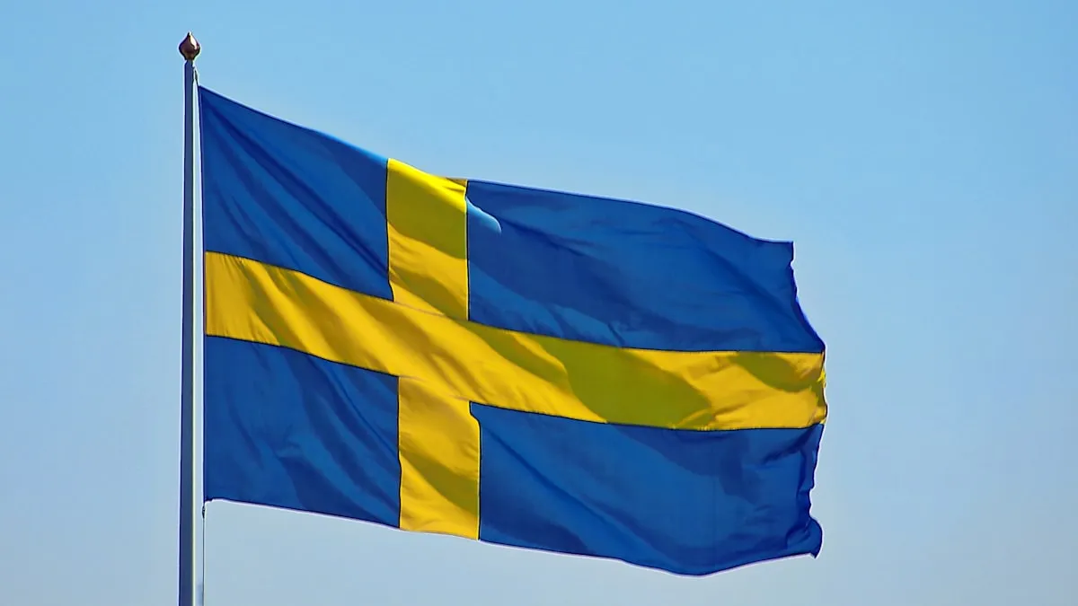 The flag of Sweden waving against a blue sky
